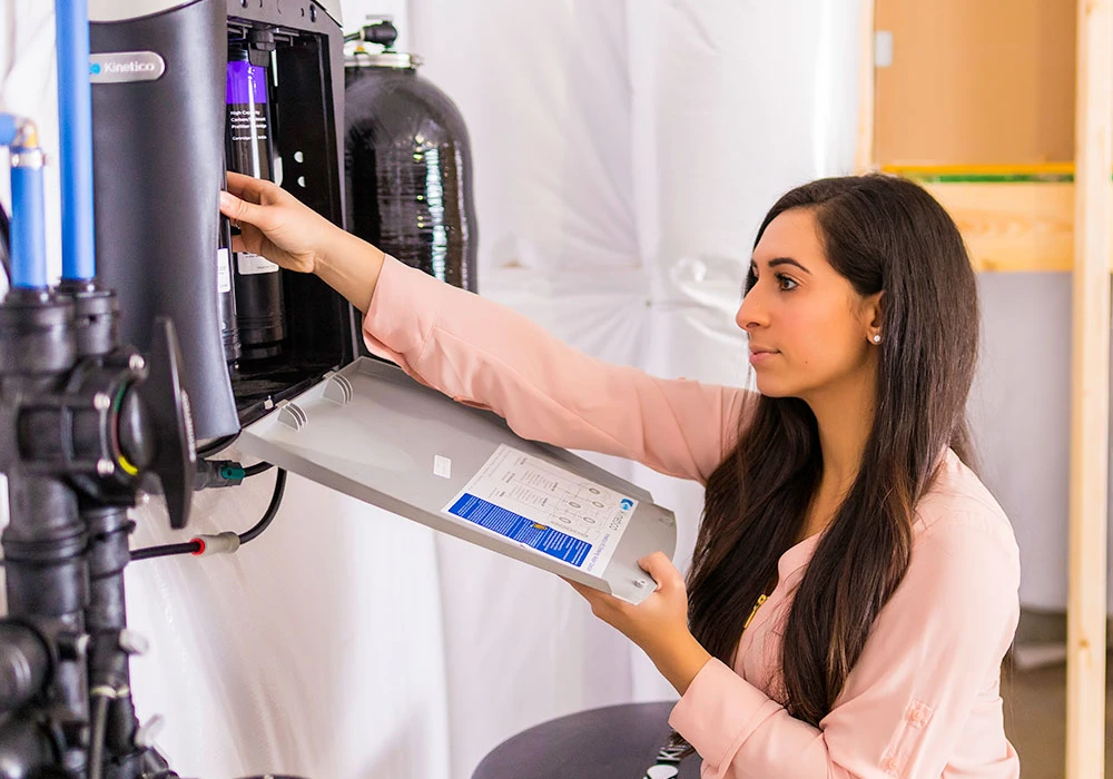 Technician checking water filtration equipment